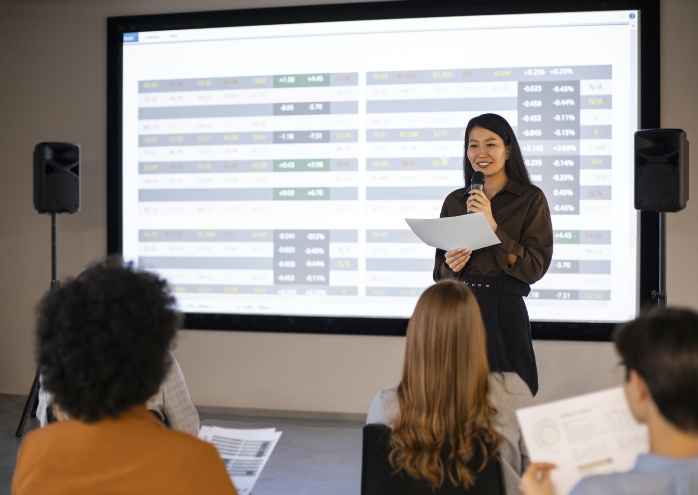 Image of speaker in front of screen to support audio visual equipment